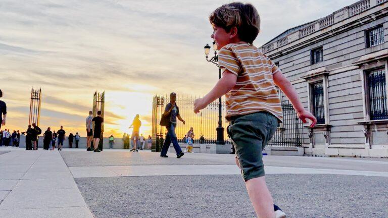 Madrid with kids guide - kid running near the Royal Palace - My Travel Monkey