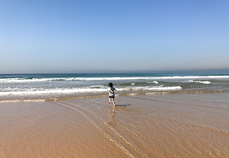 Enjoying the waves on Cascais beach near Lisbon, Portugal - My Travel Monkey