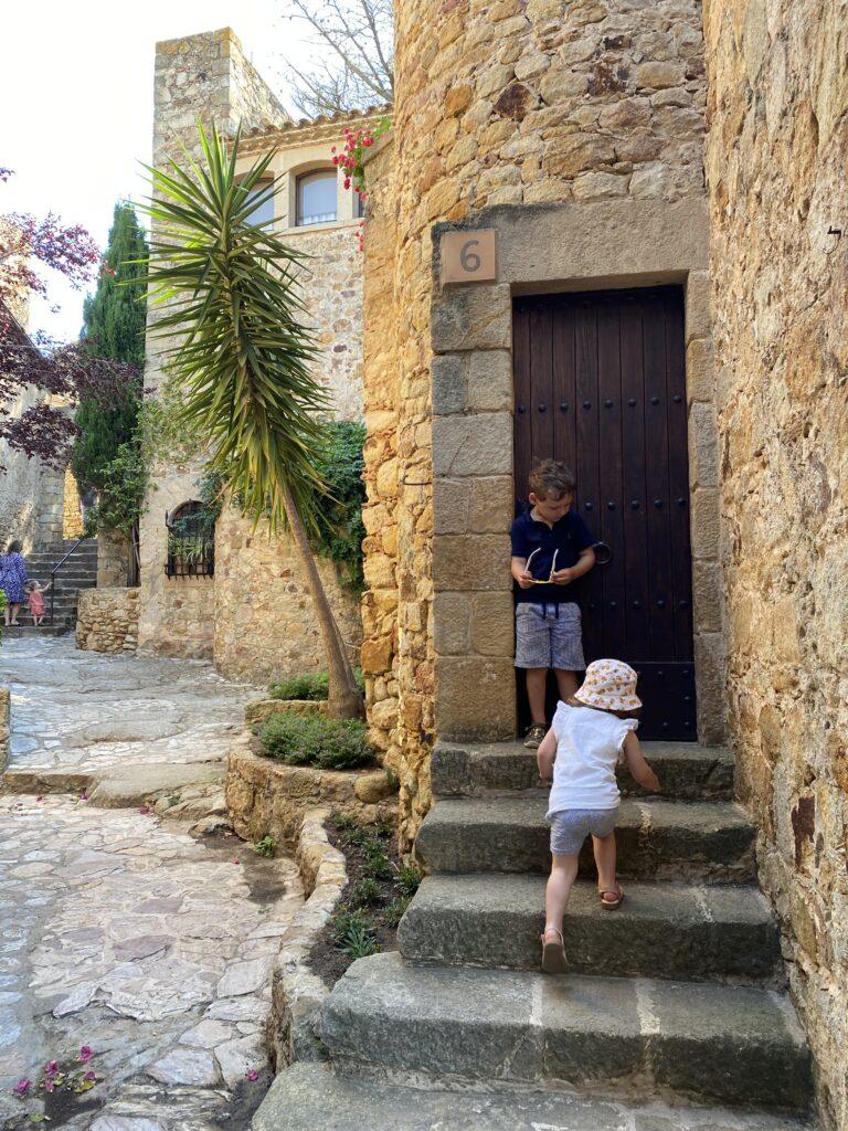 Kids exploring the town of Pals on the Costa Brava