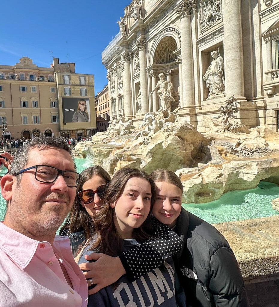 Family posing at Rome's Trevi Fountain - My Travel Monkey