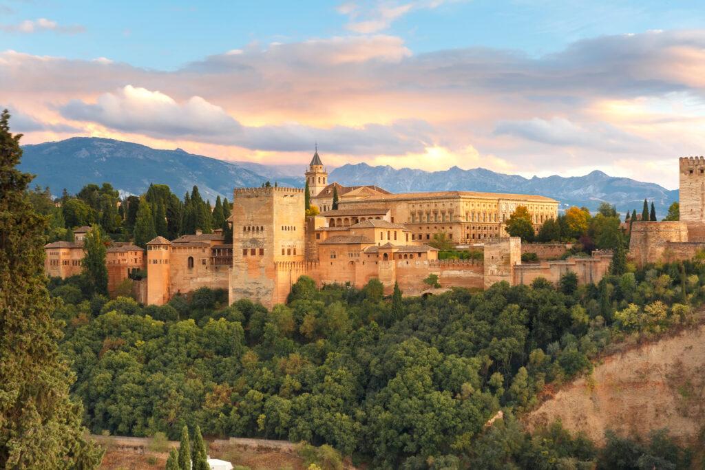 Palace and fortress complex Alhambra with Comares Tower, Palacios Nazaries and Palace of Charles V during sunset in Granada, Andalusia, Spain - My Travel Monkey