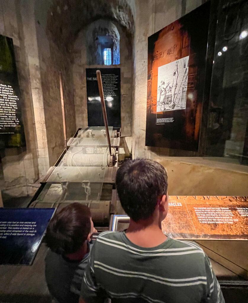 Looking at exhibits at the Tower of London with kids - My Travel Monkey
