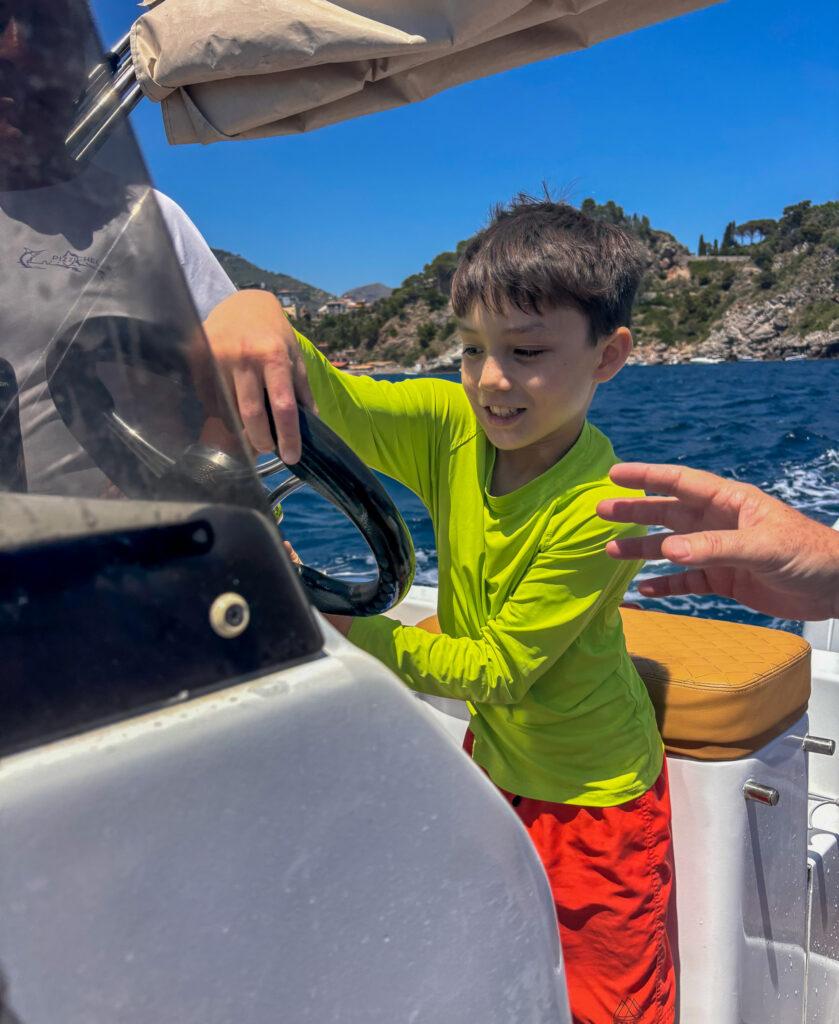 Steering a boat-Taormina-My Travel Monkey